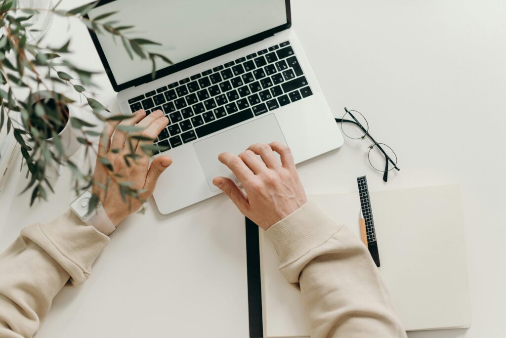pexels-photo-4065876-4065876 Person in Beige Long Sleeve Shirt Using Macbook Pro